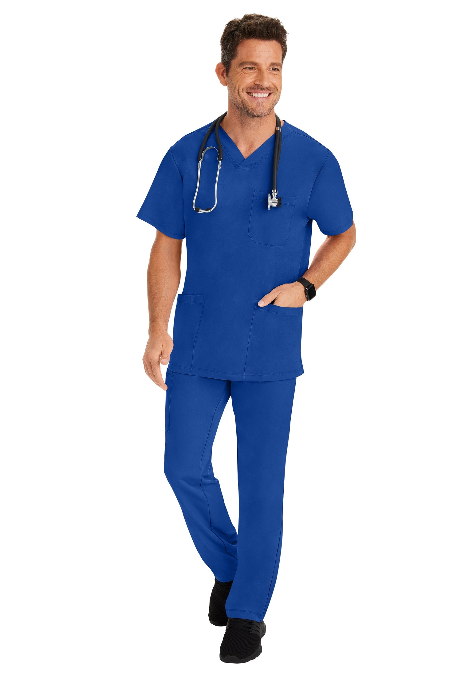 Male healthcare professional wearing royal blue men’s scrub set – Healing Hands Style 2590 top and 9590 pants by Omscrub GCC.