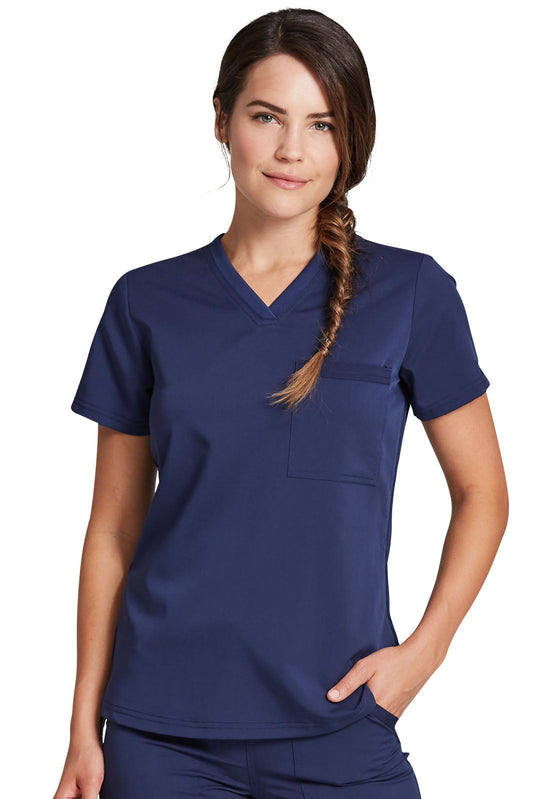 Woman wearing a navy blue scrub top, design DK812 of Dickies Balance collection